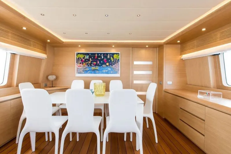  Yacht Photos Pics Luxurious dining area on 2015 Maiora 24S yacht with modern decor and elegant white chairs.