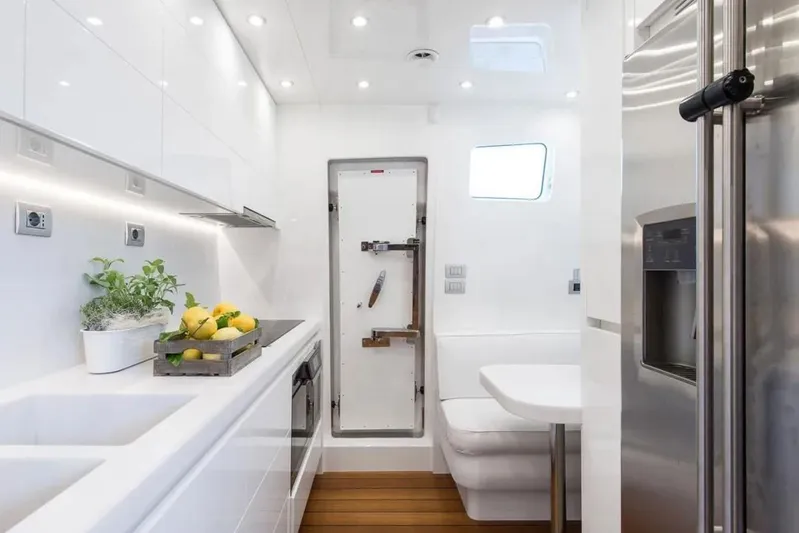  Yacht Photos Pics Modern kitchen interior on 2015 Maiora 24S yacht with sleek design and stainless steel appliances.