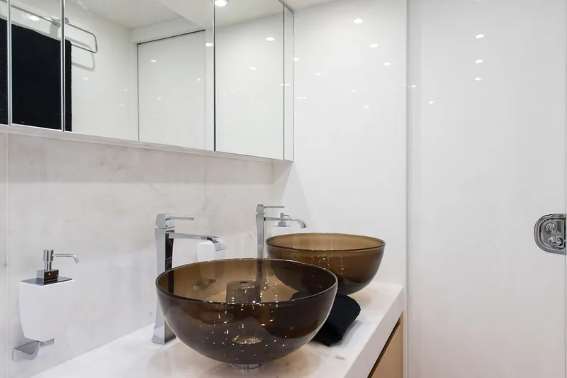  Yacht Photos Pics Luxurious Maiora 24S 2015 yacht bathroom with elegant glass vessel sinks.