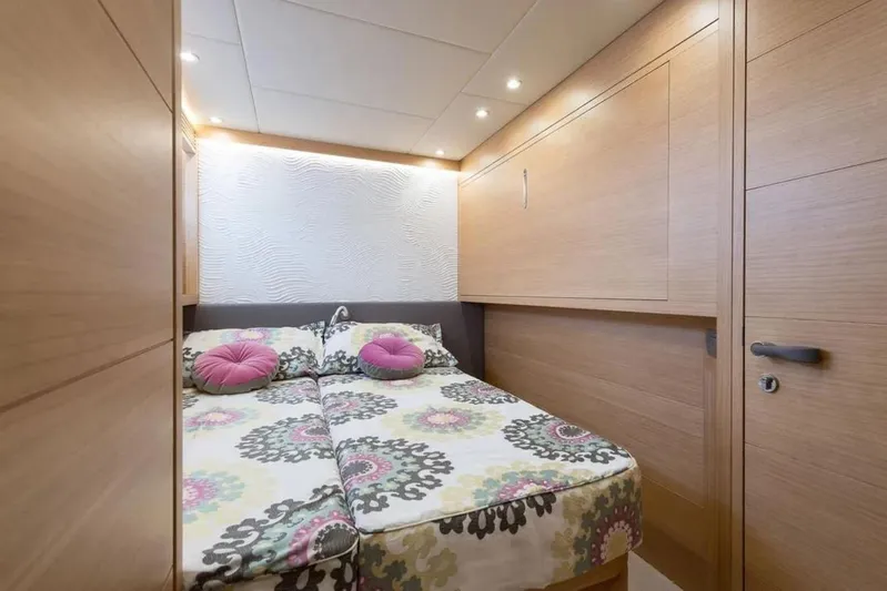  Yacht Photos Pics Luxurious Maiora 24S 2015 yacht bedroom with floral bedding and modern wood paneling.