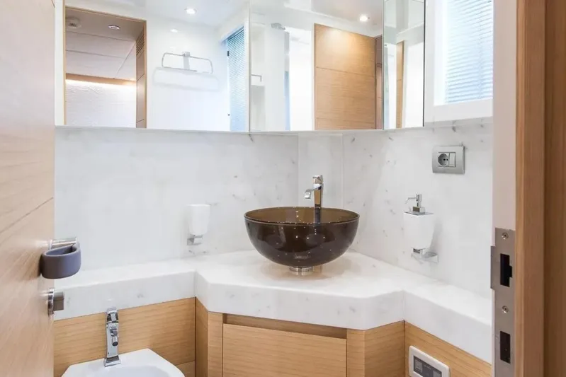  Yacht Photos Pics Luxurious bathroom in 2015 Maiora 24S yacht with modern sink and marble accents.