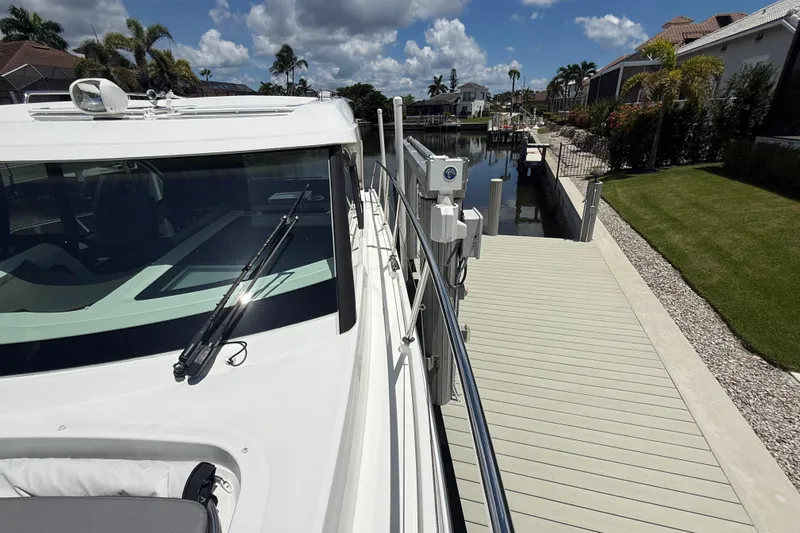  Yacht Photos Pics 2024 Beneteau Antares 11 docked, showcasing sleek design and modern features.