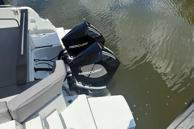  Yacht Photos Pics 2024 Beneteau Antares 11 with dual Mercury outboard engines on calm water.