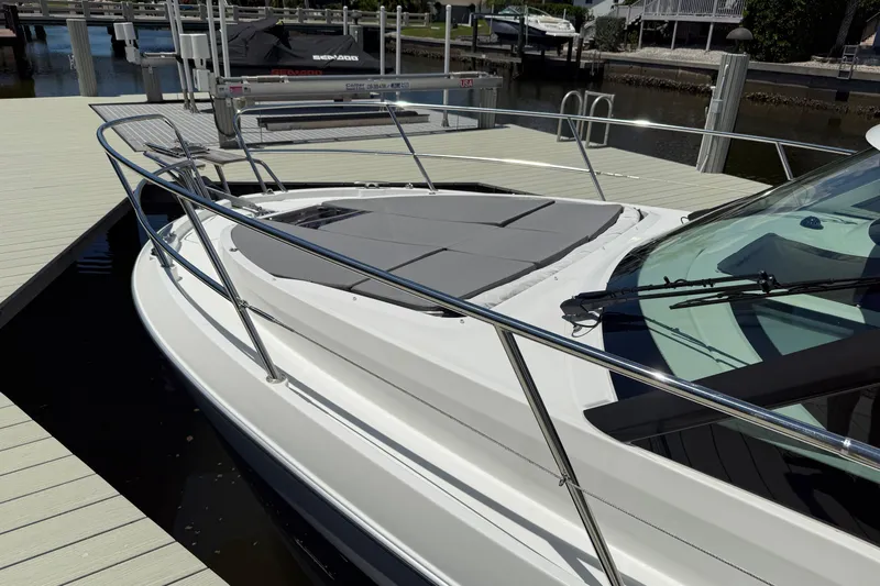  Yacht Photos Pics 2024 Beneteau Antares 11 docked, showcasing sleek design and spacious deck area.