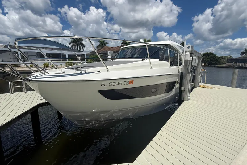  Yacht Photos Pics 2024 Beneteau Antares 11 docked under a partly cloudy sky.