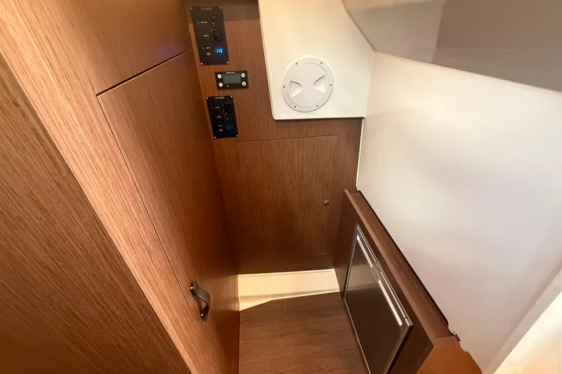  Yacht Photos Pics 2024 Beneteau Antares 11 interior with wood paneling and control panels.