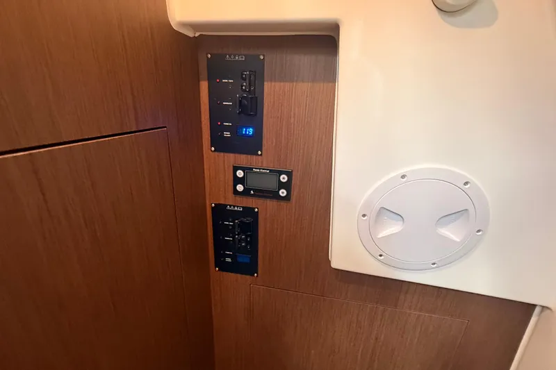  Yacht Photos Pics Control panel inside 2024 Beneteau Antares 11 boat, featuring wood finish and digital display.
