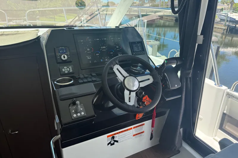  Yacht Photos Pics 2024 Beneteau Antares 11 helm with modern controls and navigation display.