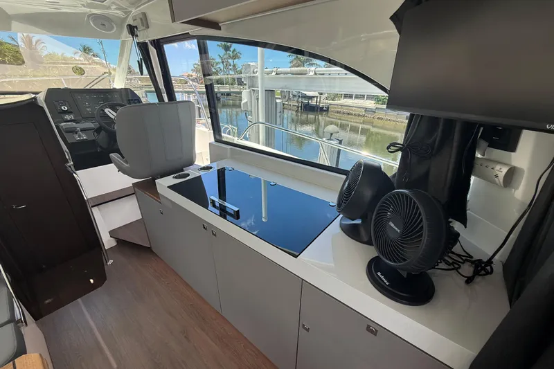  Yacht Photos Pics 2024 Beneteau Antares 11 interior with helm, seating, and modern amenities.