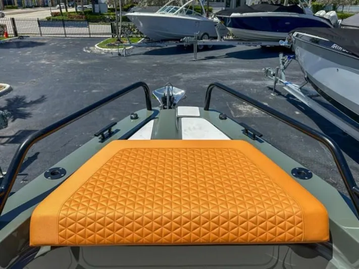  Yacht Photos Pics 2024 BRABUS Shadow 1000XC boat with orange quilted seating, docked with other boats.