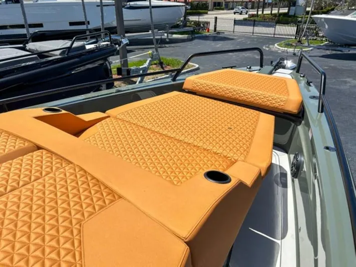  Yacht Photos Pics 2024 BRABUS Shadow 1000XC boat with orange quilted seating, docked outdoors.