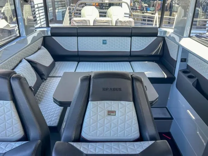  Yacht Photos Pics Luxurious interior of 2024 BRABUS Shadow 1000XC boat with quilted seating and table.