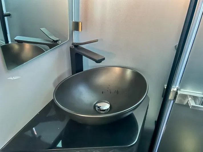  Yacht Photos Pics Modern black sink in 2024 BRABUS Shadow 1000XC yacht bathroom.