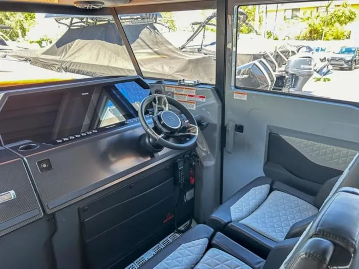  Yacht Photos Pics Interior of 2024 BRABUS Shadow 1000XC boat, featuring modern steering and seating.