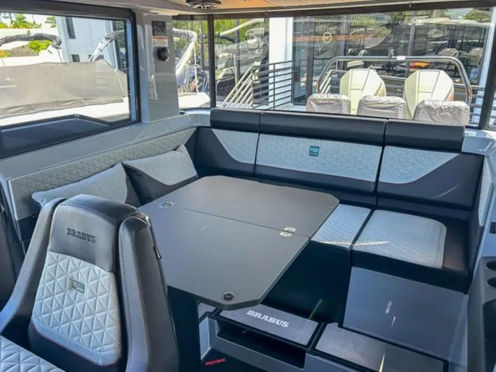  Yacht Photos Pics Luxurious interior of 2024 BRABUS Shadow 1000XC yacht with elegant seating and table.