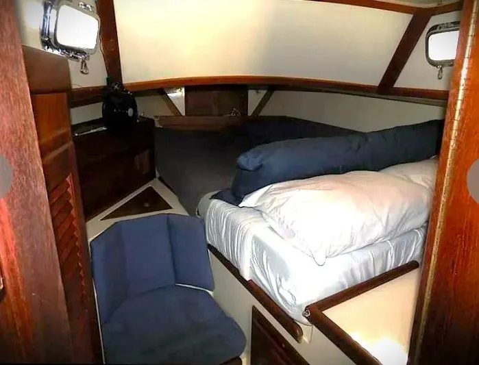 Vital Spark Yacht Photos Pics Cozy cabin interior of 1995 Pacific Seacraft 37 sailboat with bed and seating.