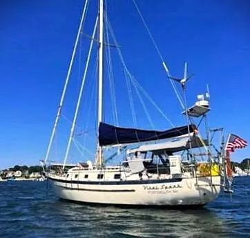 Vital Spark Yacht Photos Pics Sailboat Pacific Seacraft 37, 1995 model, anchored on a sunny day with clear blue skies.