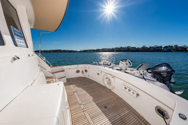 I Freedom I Yacht Photos Pics Grand Banks 49 Eastbay SX 2005 yacht deck under sunny skies on calm waters.