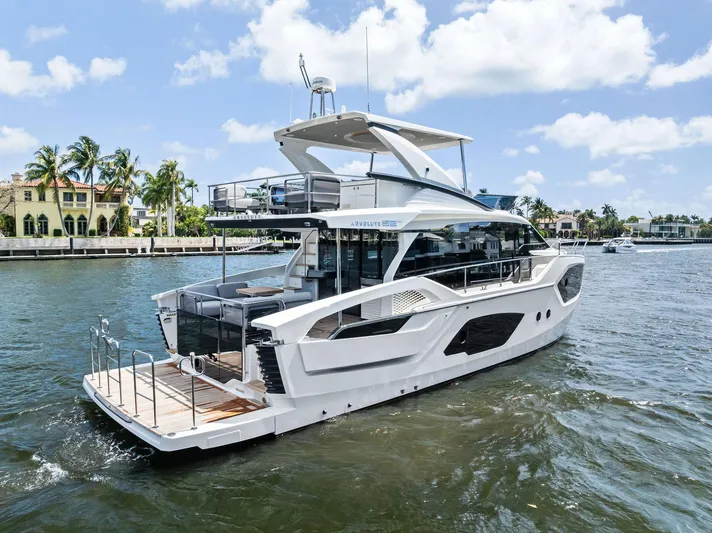 Lobster Tails Yacht Photos Pics 2023 Absolute 52 FLY yacht cruising on a sunny day, showcasing sleek design and luxury features.