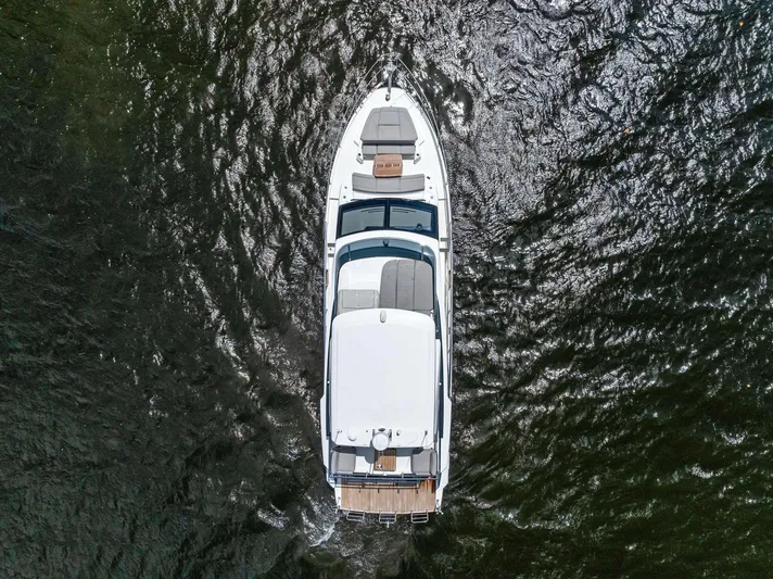 Lobster Tails Yacht Photos Pics Aerial view of 2023 Absolute 52 FLY yacht cruising on water.