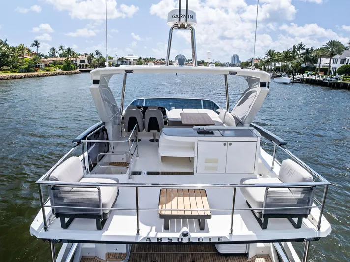 Lobster Tails Yacht Photos Pics 2023 Absolute 52 FLY yacht on water, featuring spacious deck and modern design.