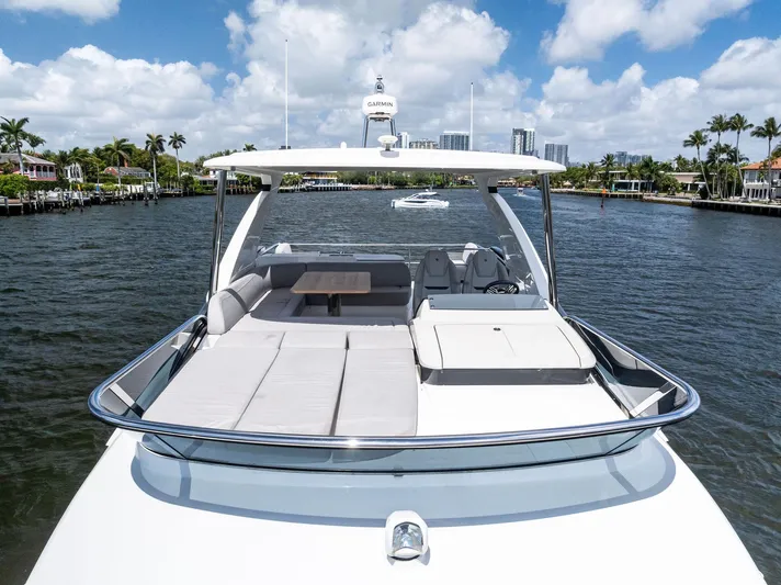 Lobster Tails Yacht Photos Pics 2023 Absolute 52 FLY yacht on water, featuring spacious deck and luxurious seating.