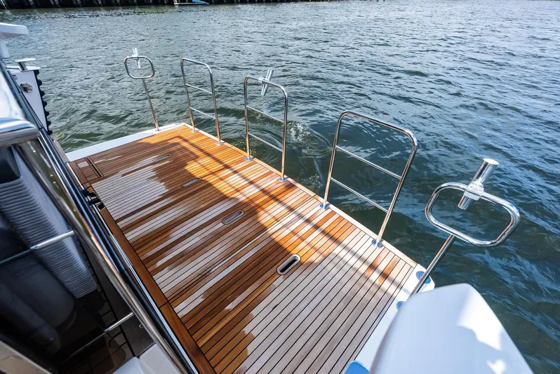 Lobster Tails Yacht Photos Pics Luxury yacht Absolute 52 FLY 2023, featuring elegant teak deck by the water.