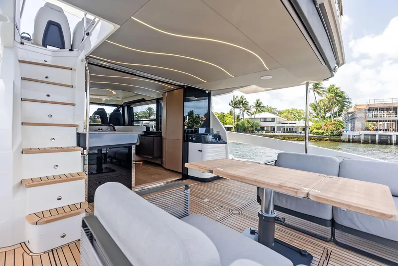 Lobster Tails Yacht Photos Pics Luxurious 2023 Absolute 52 FLY yacht interior with modern seating and scenic water view.