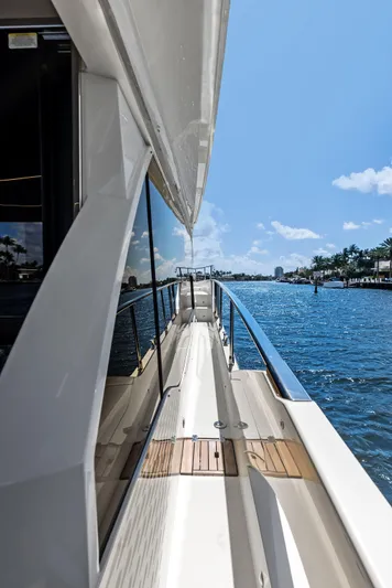 Lobster Tails Yacht Photos Pics Side view of 2023 Absolute 52 FLY yacht on a sunny day.