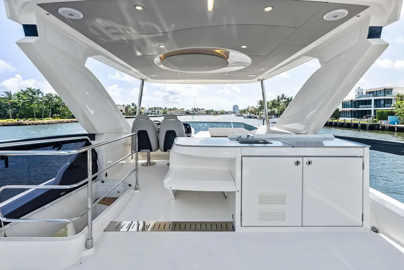Lobster Tails Yacht Photos Pics Luxurious 2023 Absolute 52 FLY yacht deck with modern amenities and scenic waterfront view.