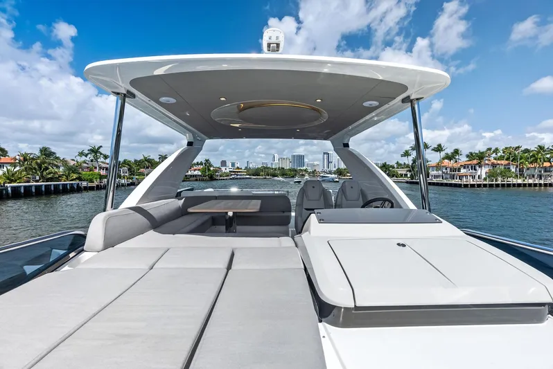 Lobster Tails Yacht Photos Pics Luxury Absolute 52 FLY yacht, 2023 model, with spacious deck and modern design on a sunny day.