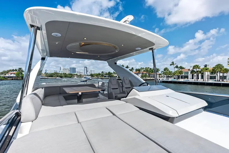 Lobster Tails Yacht Photos Pics Luxurious 2023 Absolute 52 FLY yacht with spacious deck and modern design, cruising on a sunny day.