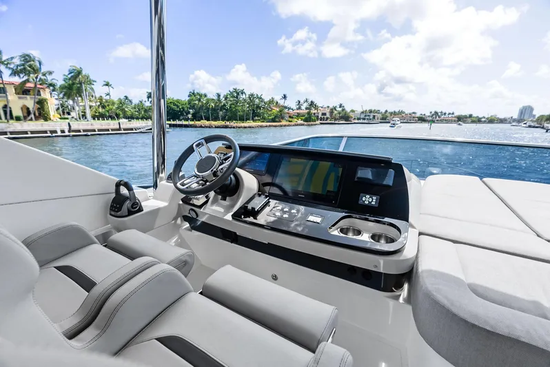 Lobster Tails Yacht Photos Pics Cockpit of 2023 Absolute 52 FLY yacht with modern controls and ocean view.