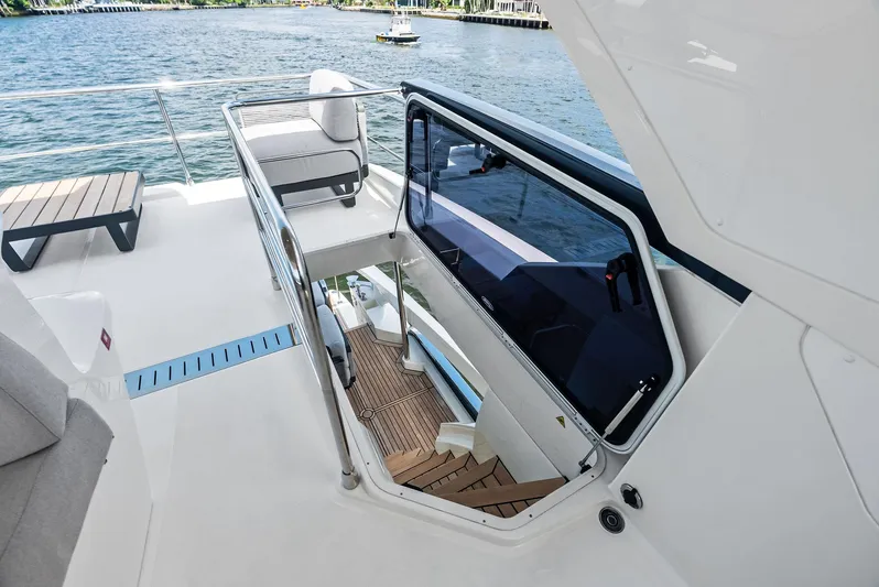 Lobster Tails Yacht Photos Pics Flybridge view of 2023 Absolute 52 FLY yacht with stairs leading below deck.