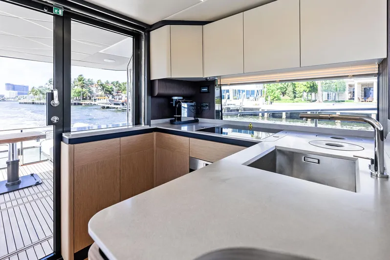Lobster Tails Yacht Photos Pics Modern kitchen on 2023 Absolute 52 FLY yacht with sleek countertops and waterfront view.