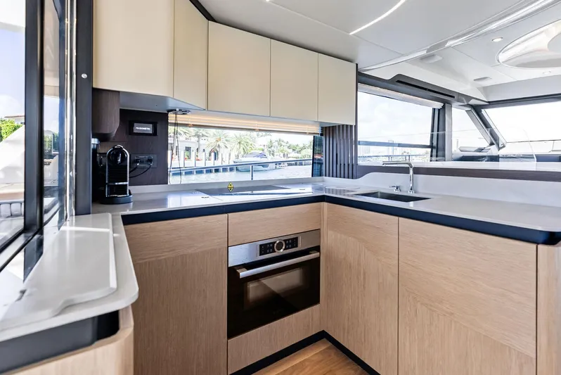 Lobster Tails Yacht Photos Pics Modern kitchen interior on 2023 Absolute 52 FLY yacht, featuring sleek cabinetry and appliances.