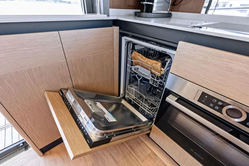 Lobster Tails Yacht Photos Pics Modern kitchen with open dishwasher on Absolute 52 FLY yacht, 2023 model.