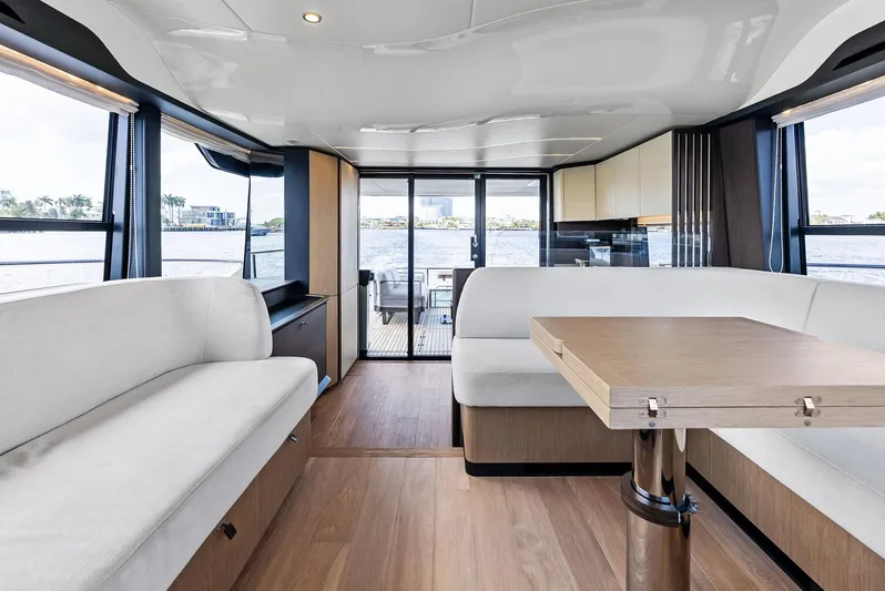 Lobster Tails Yacht Photos Pics Luxurious interior of 2023 Absolute 52 FLY yacht with modern seating and dining area.