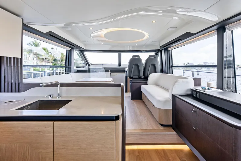 Lobster Tails Yacht Photos Pics Luxurious interior of 2023 Absolute 52 FLY yacht with modern design and panoramic windows.