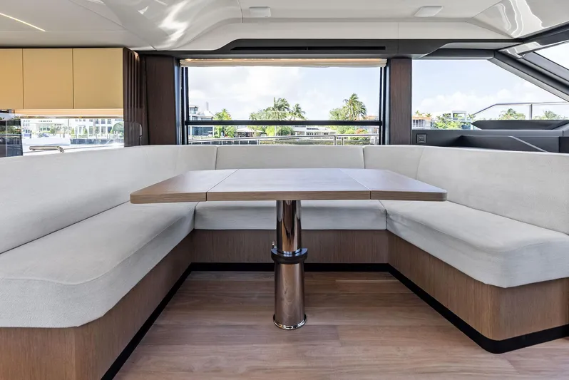 Lobster Tails Yacht Photos Pics Luxurious interior of 2023 Absolute 52 FLY yacht with elegant seating and table.