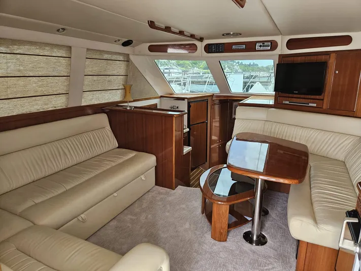  Yacht Photos Pics Luxurious interior of 2007 Riviera 42 yacht with plush seating and wooden accents.