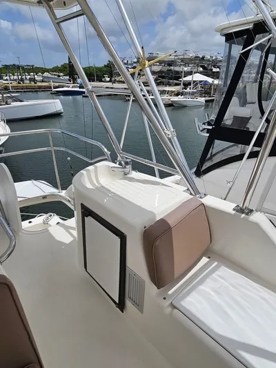  Yacht Photos Pics 2007 Riviera 42 yacht deck with seating, docked in marina under blue sky.