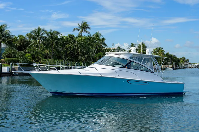 Galene Yacht Photos Pics 2013 Viking 42 Open yacht on calm water with palm trees in the background.