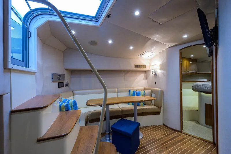 Galene Yacht Photos Pics Interior of 2013 Viking 42 Open yacht with seating, table, and modern lighting.