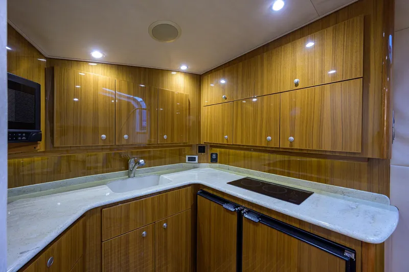Galene Yacht Photos Pics Luxurious kitchen interior of 2013 Viking 42 Open yacht with wooden cabinets and modern appliances.