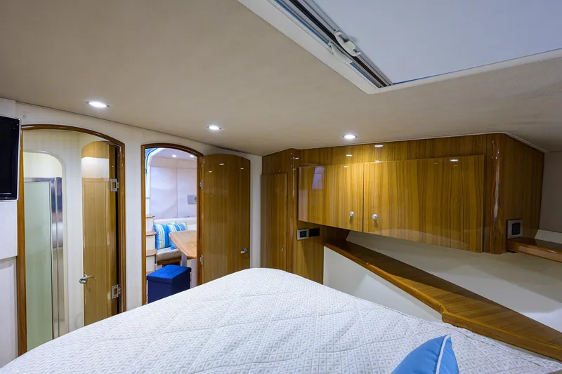 Galene Yacht Photos Pics Luxurious interior of 2013 Viking 42 Open yacht with wood finish and cozy bedding.