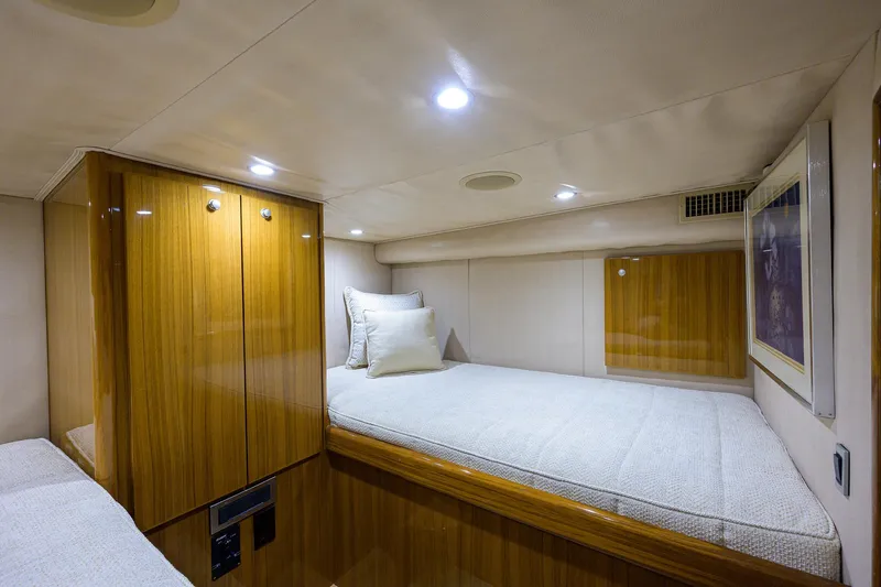 Galene Yacht Photos Pics 2013 Viking 42 Open cabin interior with wooden cabinetry and cozy bedding.