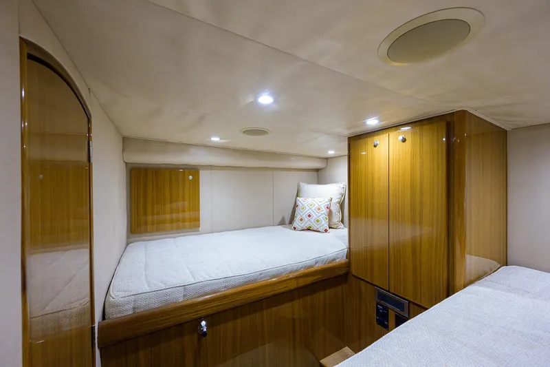 Galene Yacht Photos Pics 2013 Viking 42 Open cabin interior with wooden finish and cozy bedding.