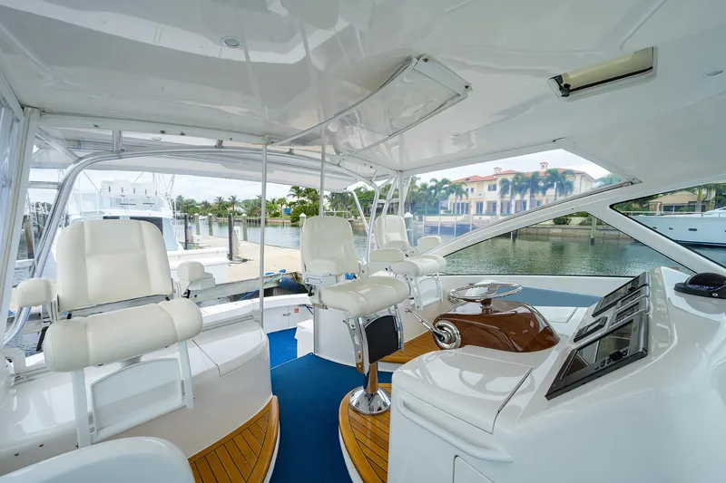 Galene Yacht Photos Pics 2013 Viking 42 Open yacht interior with white seating and modern helm.