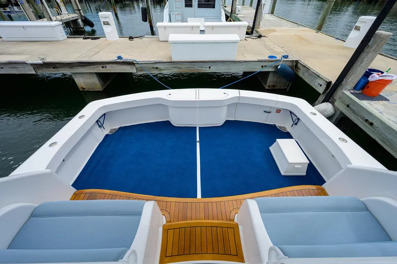 Galene Yacht Photos Pics 2013 Viking 42 Open yacht with blue deck and wooden accents at a marina.